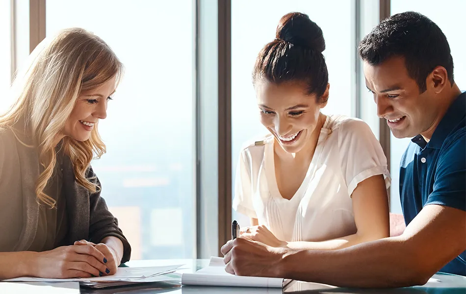 Customer meeting with advisors who review agreements and documents.